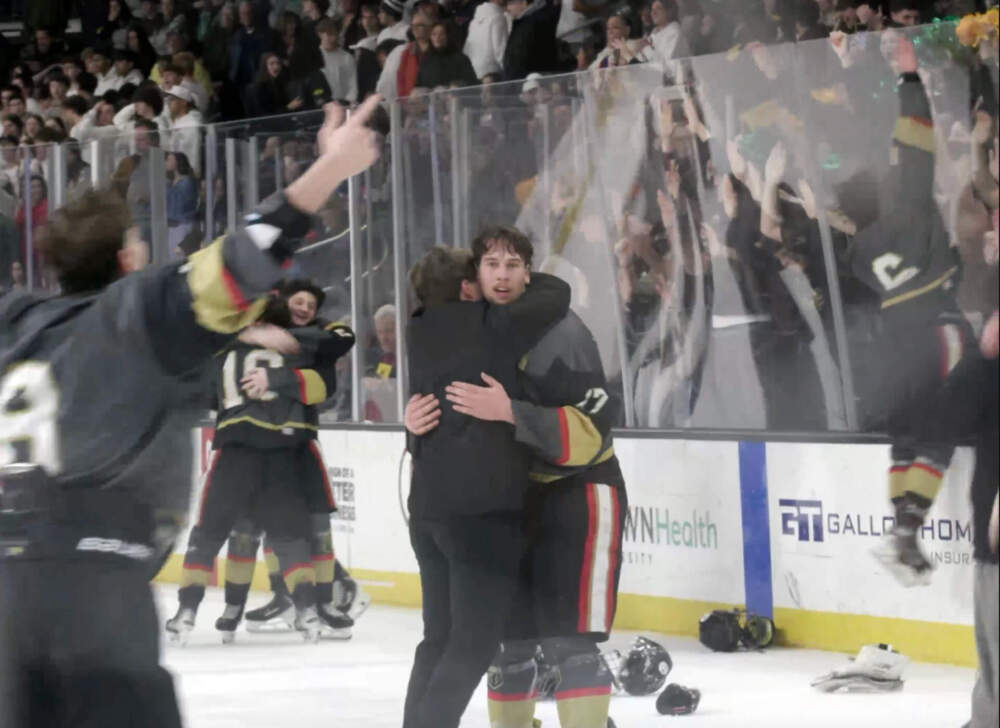 Colin Dorgan and teammates celebrate after the Blackstone Valley Schools co-op clinches the state championship on Wednesday, March 18, 2026 in Providence. (Blake Carpentier/Ocean State Media)
