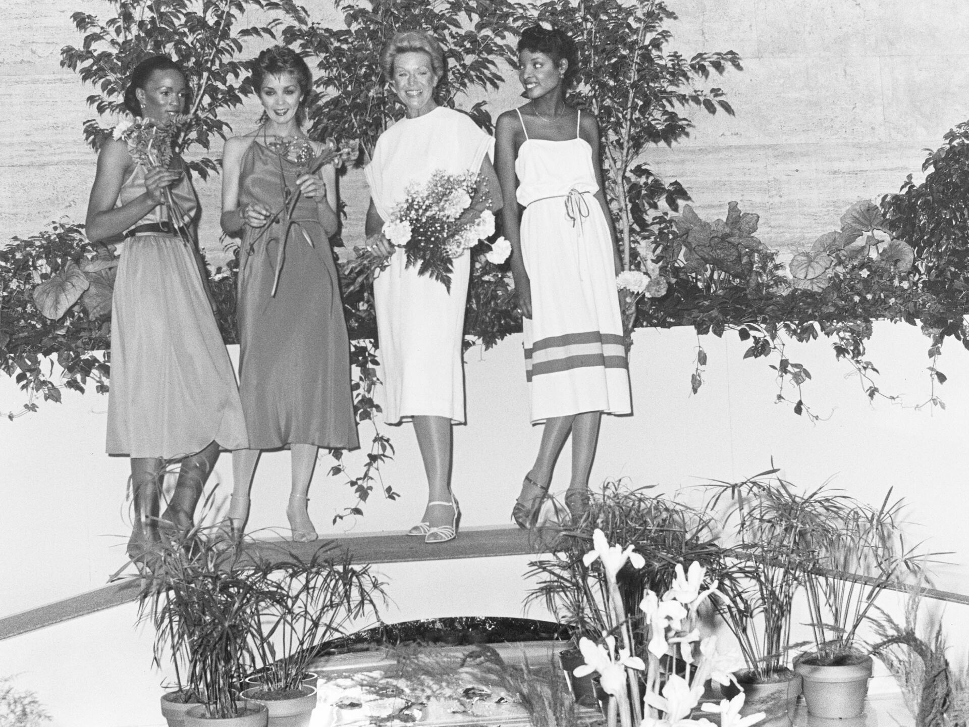 Attendees with floral arrangements on display as part of the 1979 "Art in Bloom" at the Museum of Fine Arts, Boston. (Courtesy Museum of Fine Arts, Boston)