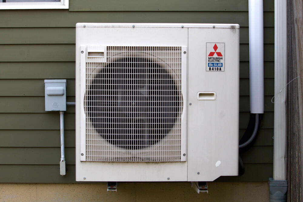The outdoor unit of Jose Juste's heat pump system in Newburyport. (Miriam Wasser/WBUR)