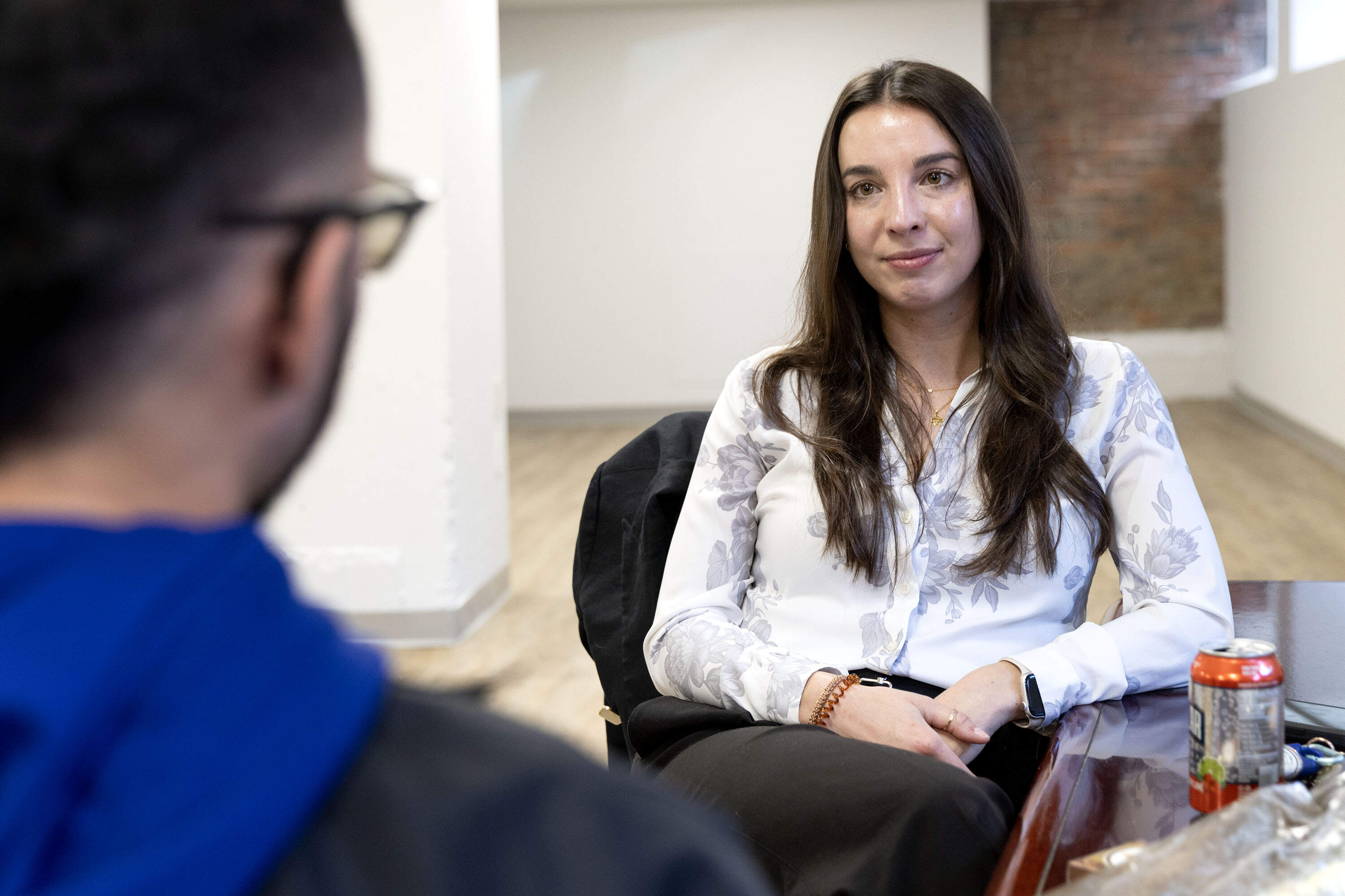 Attorney Daniela Hargus talks with Alejandro Orrego Agudelo, her client who was held in ICE detention for four months. (Robin Lubbock/WBUR)