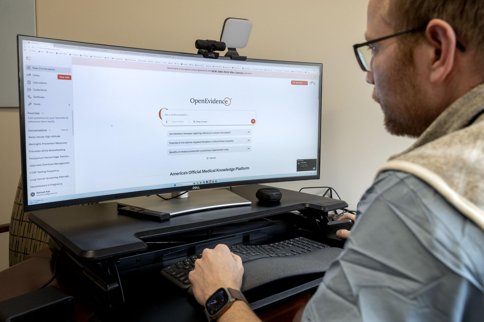 Critical care doctor Sam Ash looks at OpenEvidence, an AI medical information platform, on his computer at South Shore Health in Weymouth. (Robin Lubbock/WBUR)
