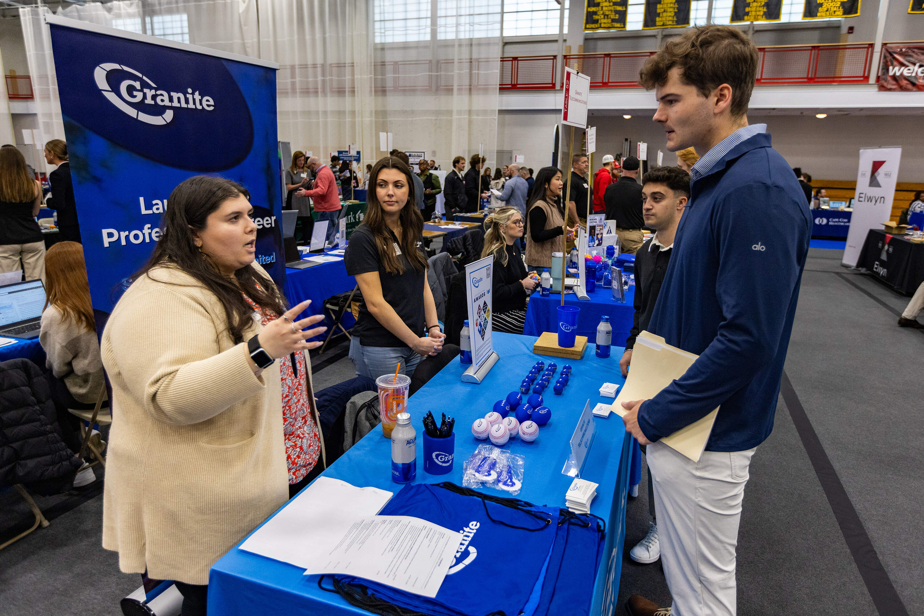 Senior Louie Jennings listens to a representative from Granite Telecommunications during the Bridgewater State University's MEGA Job &amp; Internship Fair. (Jesse Costa/WBUR)