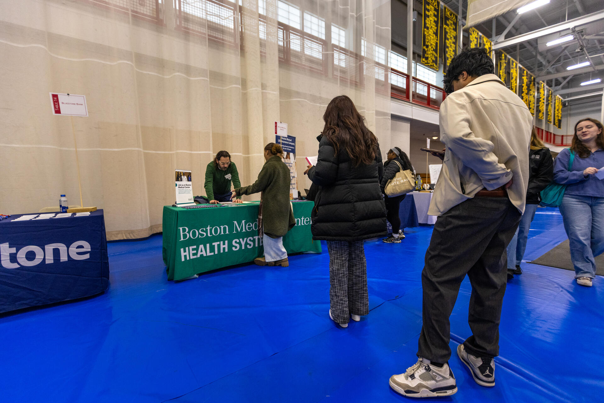 Students stand in line to speak with a representative with Boston Medical Center at a Bridgewater State University career fair. (Jesse Costa/WBUR)
