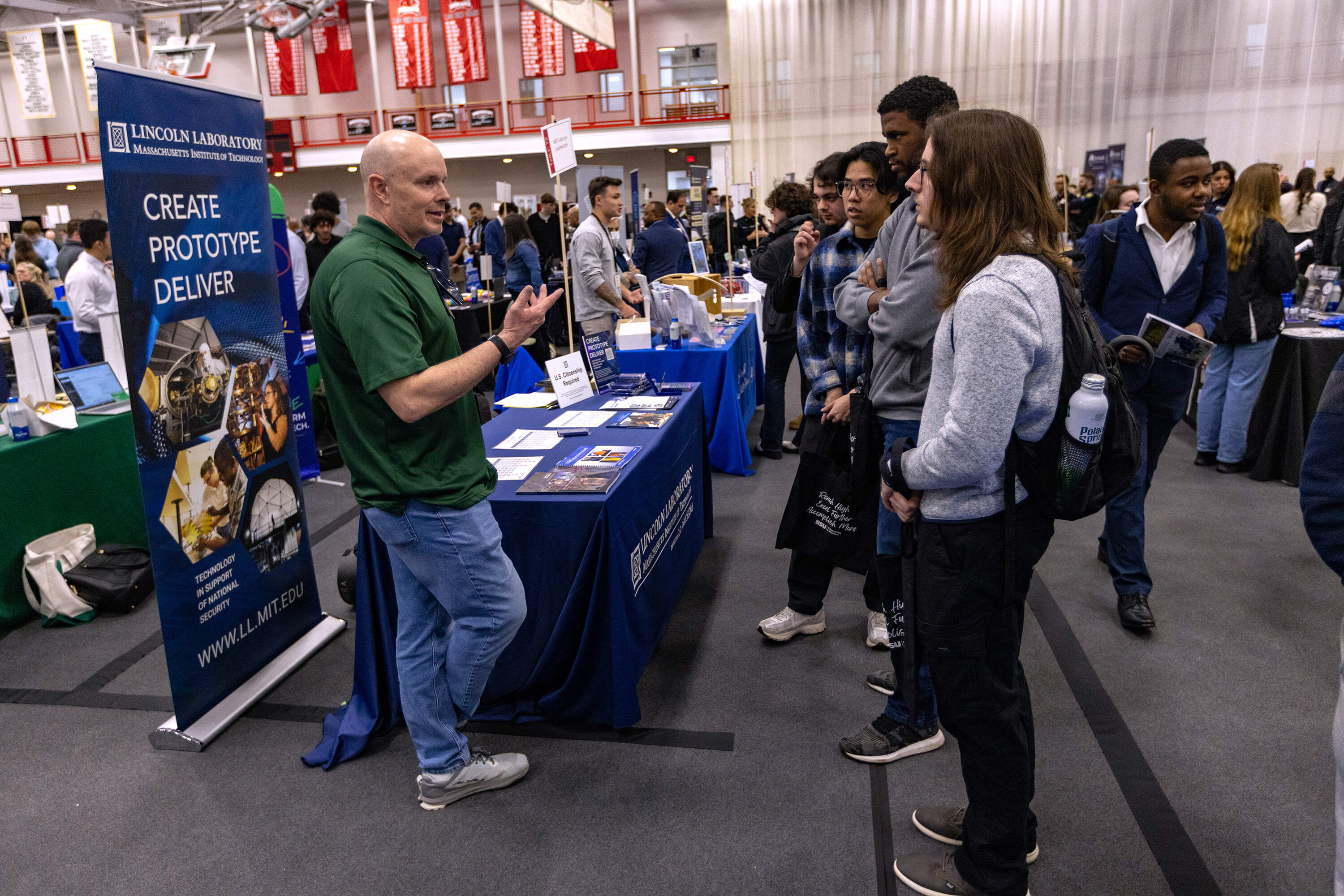 Students listen to a representative from Lincoln Laboratories during the Bridgewater State University's MEGA Job & Internship Fair. (Jesse Costa/WBUR)