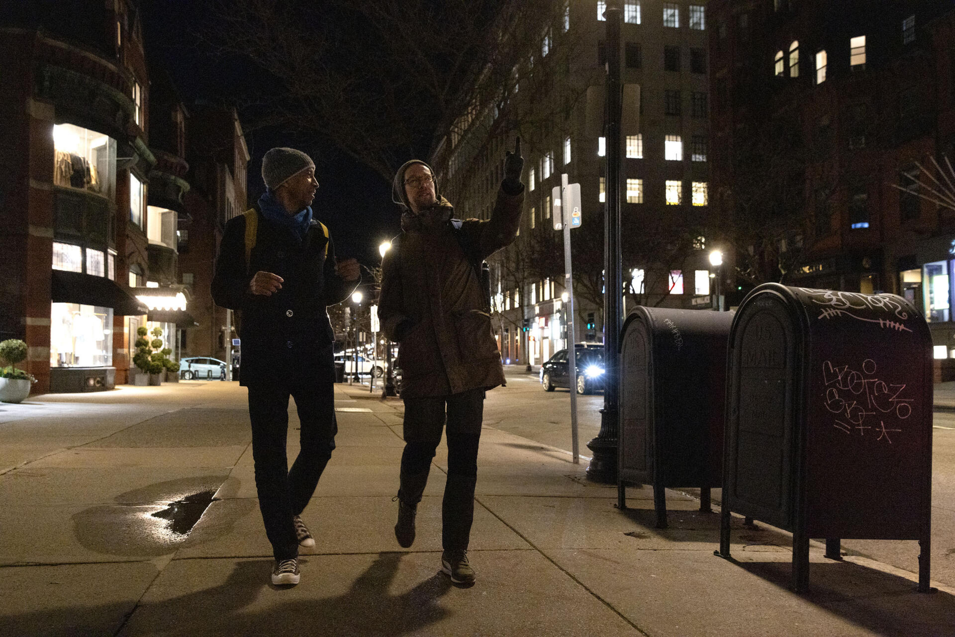 Artists, researchers and soundwalkers Garnette Cadogan and Jacek Smolicki walk along Newbury Street in Boston's Back Bay. (Robin Lubbock/WBUR)