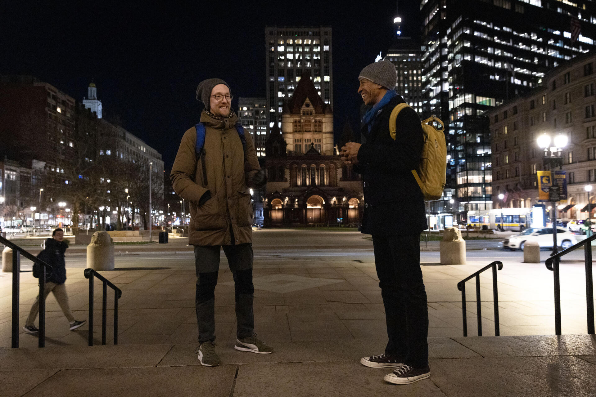 Jacek Smolicki and Garnette Cadogan talk in Boston's Copley Square, the starting point for their evening soundwalk to Cambridge. (Robin Lubbock/WBUR)