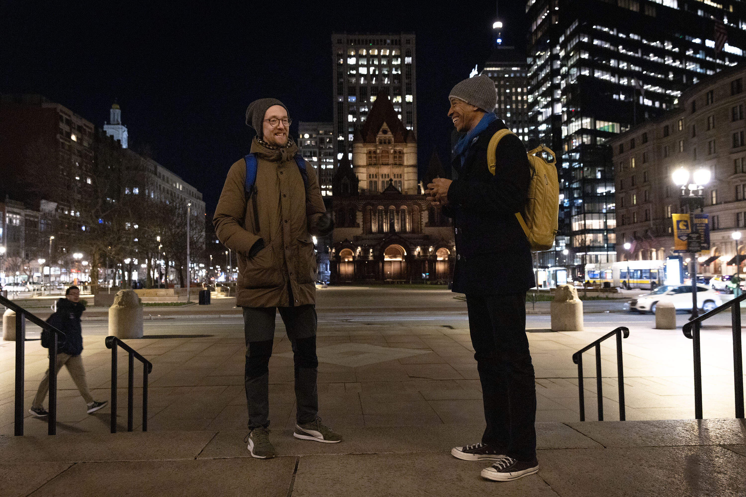 Jacek Smolicki and Garnette Cadogan talk in Boston's Copley Square, the starting point for their evening soundwalk to Cambridge. (Robin Lubbock/WBUR)