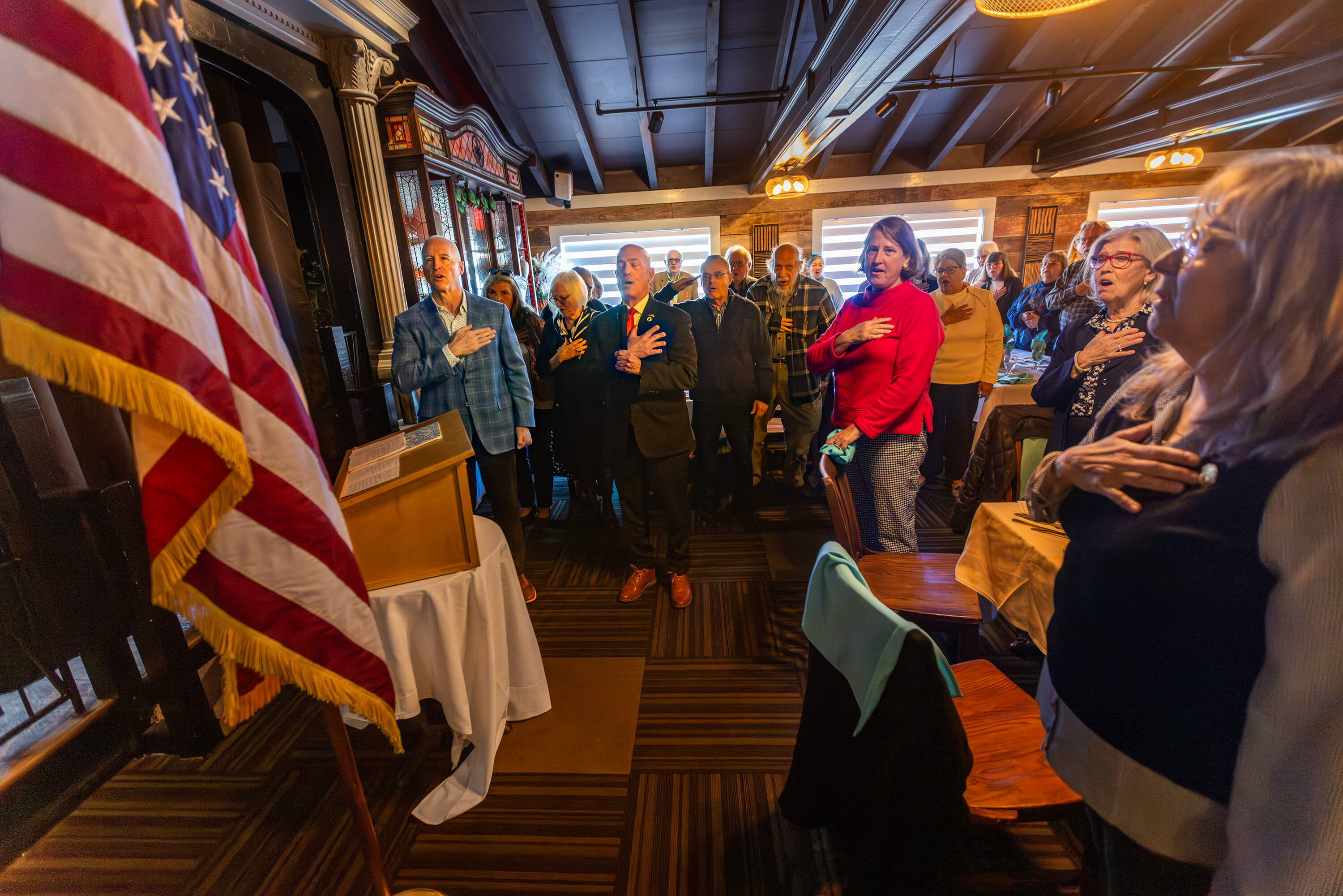 At the beginning of the luncheon, Minogue joined the Republican Women’s Club in reciting the Pledge of Allegiance. (Jesse Costa/WBUR)