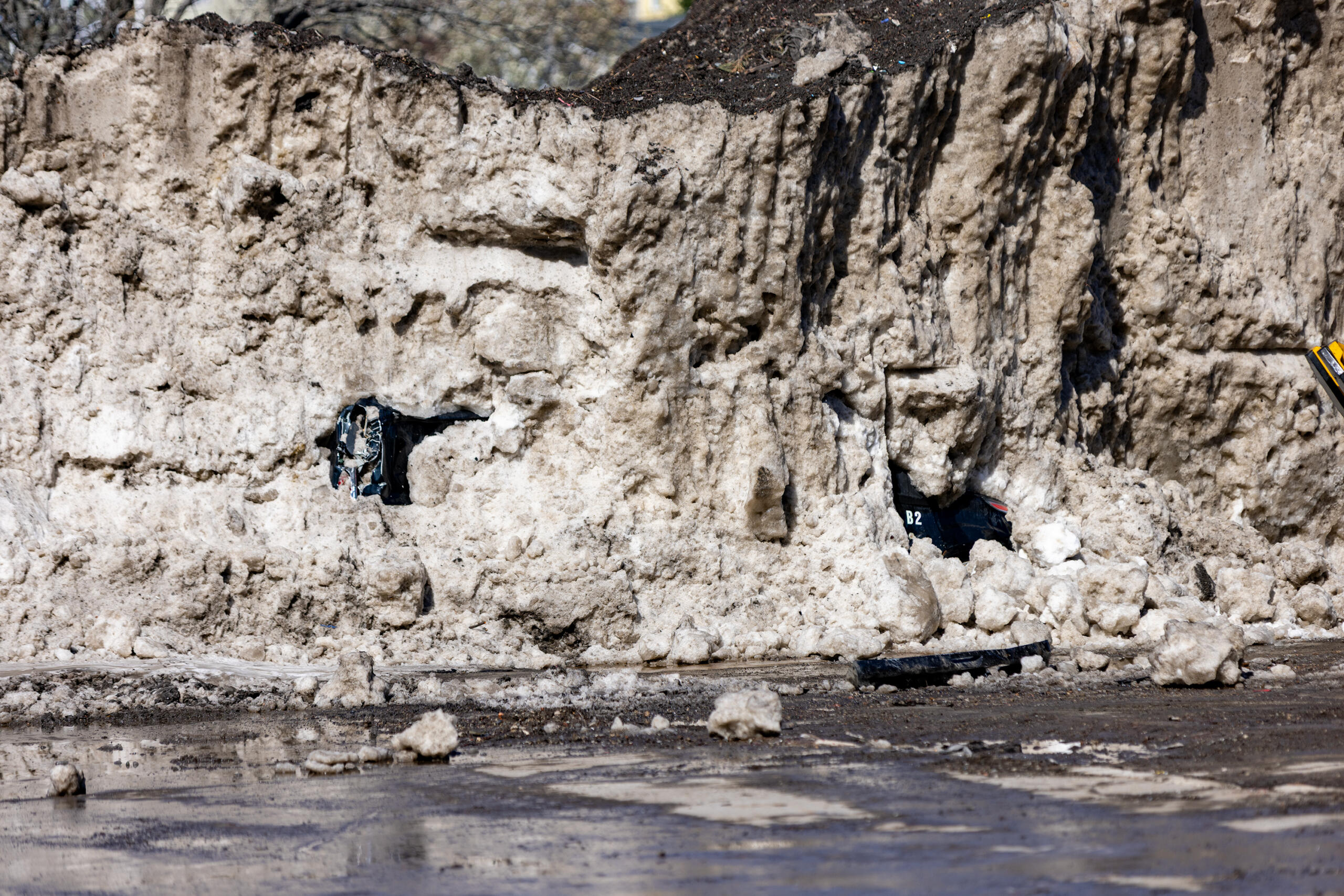 A Somerville city van buried under a massive pile of snow in a vacant lot on Washington Street. 