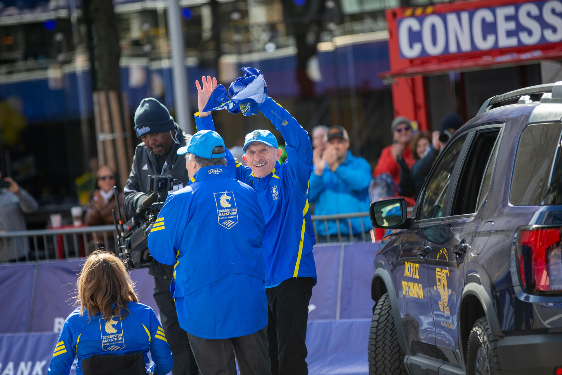 This year's grand marshal, Jack Fultz, arrives at the finish line in Boston. (Jesse Costa/WBUR)