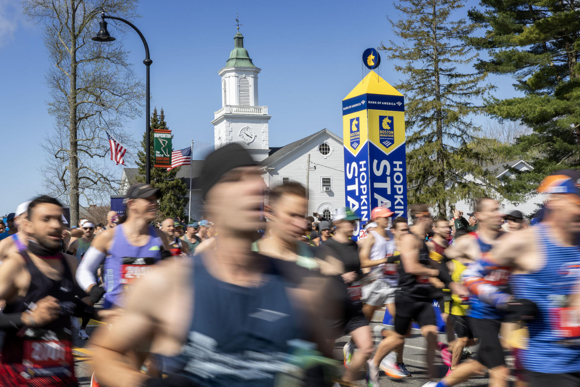 Runners in Wave 1 cross the starting line of the 130th Boston Marathon. (Robin Lubbock/WBUR)