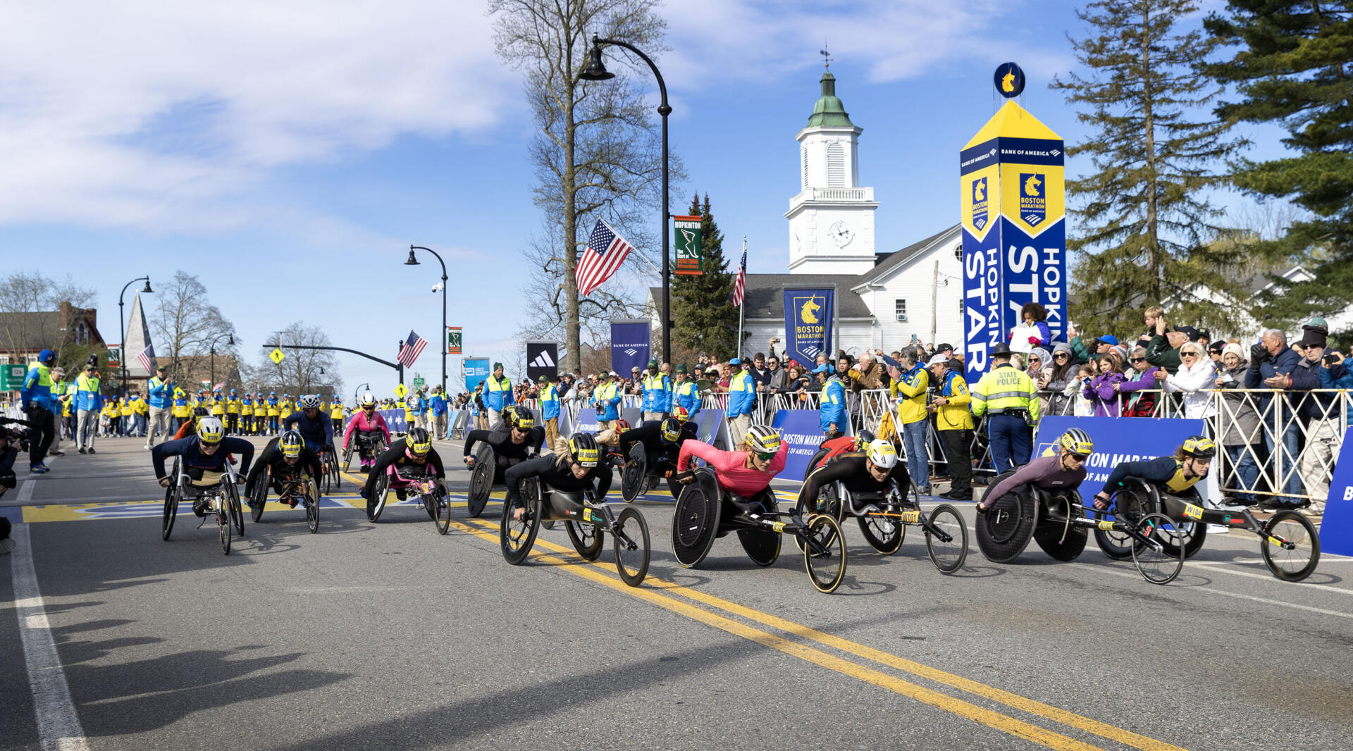 Competitors in the Women's wheelchair division of the 130th Boston Marathon cross the start line. (Robin Lubbock/WBUR)