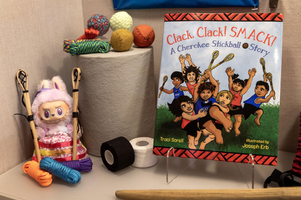 Stickball balls made from leather and cord, and a children's book about stickball at the "Stickball @ Harvard" exhibit at Harvard's Peabody Museum, in Cambridge. (Robin Lubbock/WBUR)