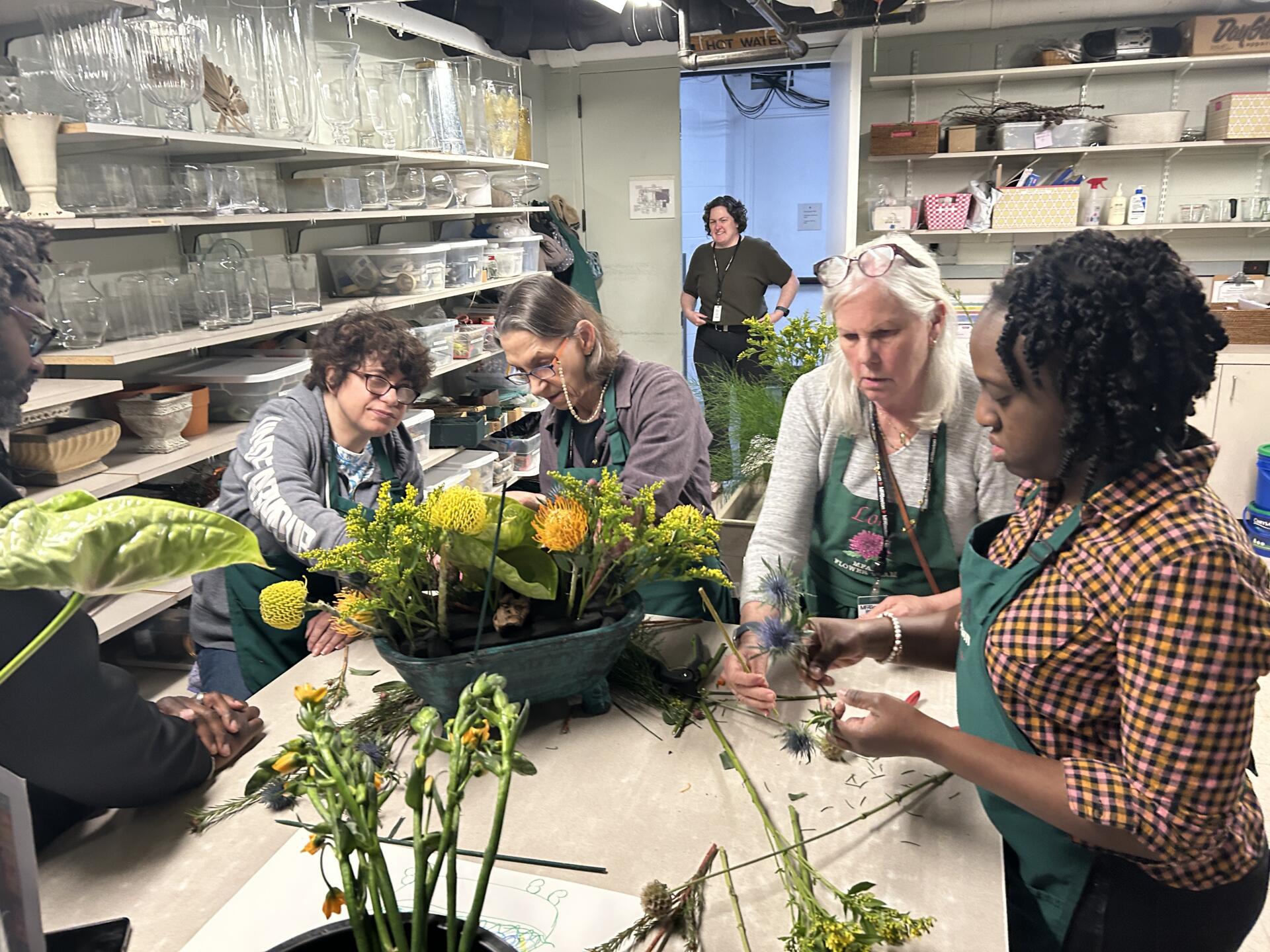 From left, Amy Caliri, Laura Rossinow, Lori Walsh and Betty Antoine work on their floral arrangement on behalf of Gateway Arts. (Courtesy of Aurore Dinwoodie)