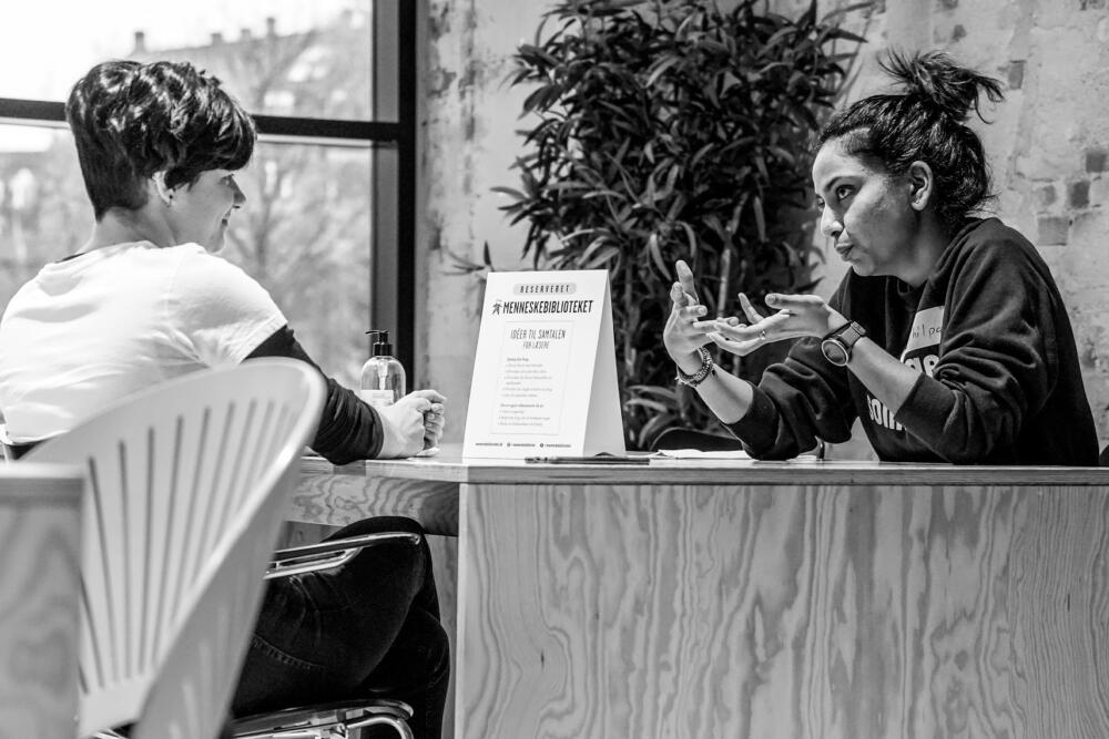 A book, right, speakers with her reader about the experience of immigrating to Denmark from India at the at Noerrebro Public Library in Northbridge, a borough in the city of Copenhagen. (Elin Tabitha Hansen / Courtesy Human Library Organization)
