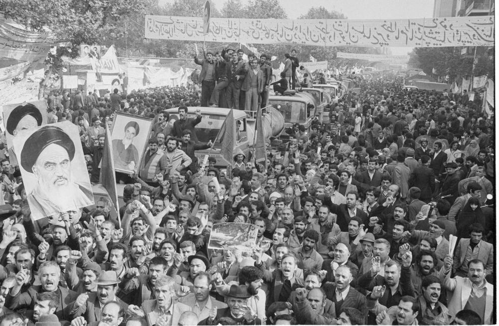 In this Nov. 27, 1979 file photo, demonstrators, including oil tank drivers with their vehicles, protest in front of the U.S. Embassy in Tehran, Iran. (Mohammad Sayad/AP)