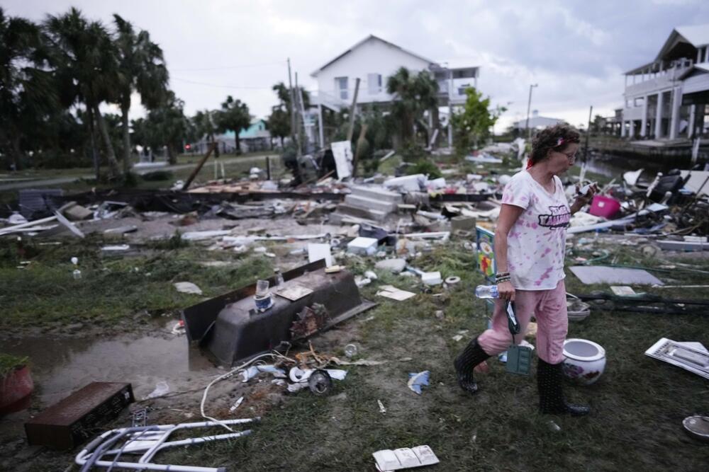Jewell Baggett walks amidst debris where her mother's home once stood, in Horseshoe Beach, Fla., after the passage of Hurricane Idalia, on Aug. 30, 2023. (Rebecca Blackwell, File/ AP)