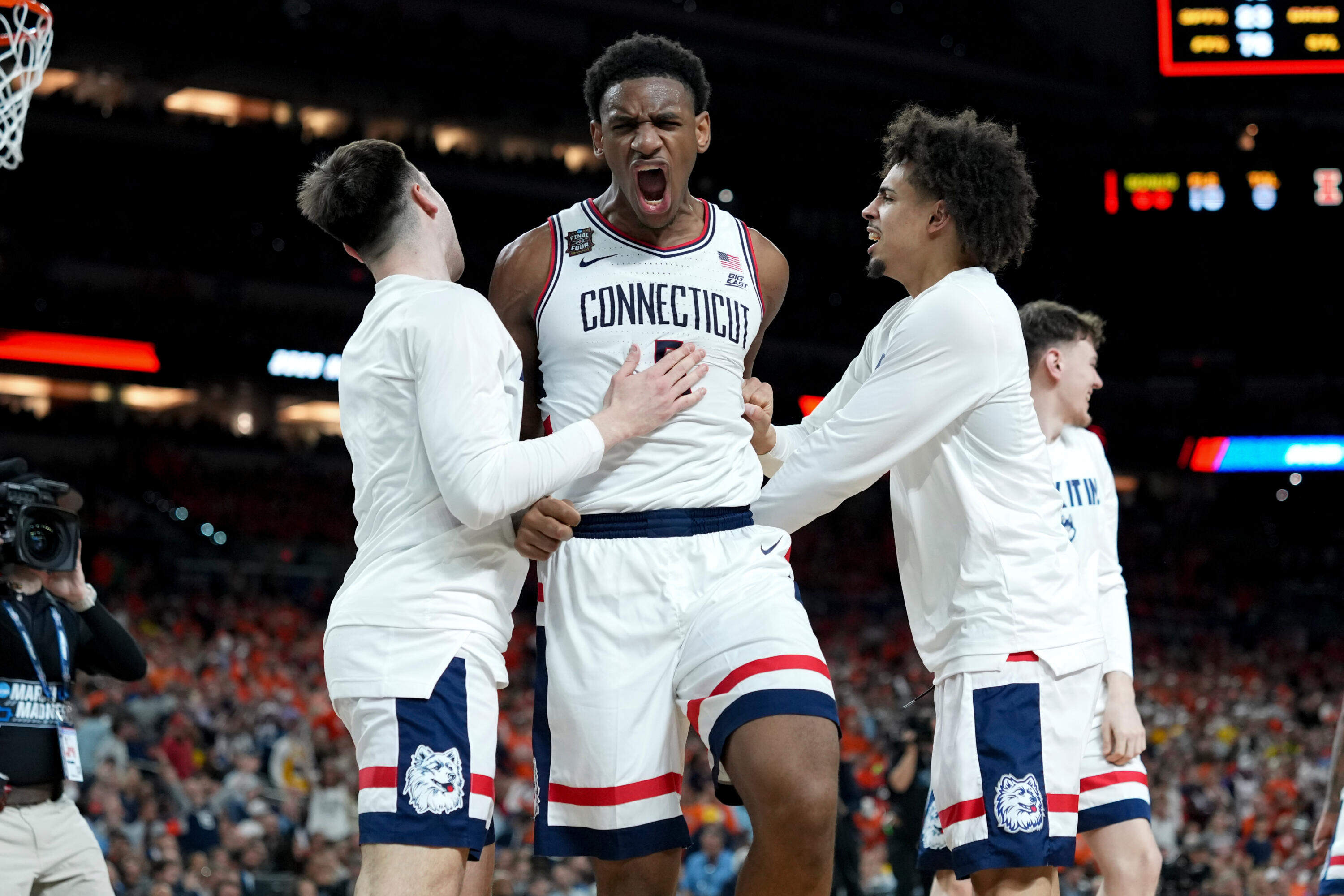 UConn forward Tarris Reed Jr., center, celebrates after the second half of an NCAA college basketball tournament semifinal game against Illinois at the Final Four, Saturday, April 4, 2026, in Indianapolis. (AP Photo/Abbie Parr)