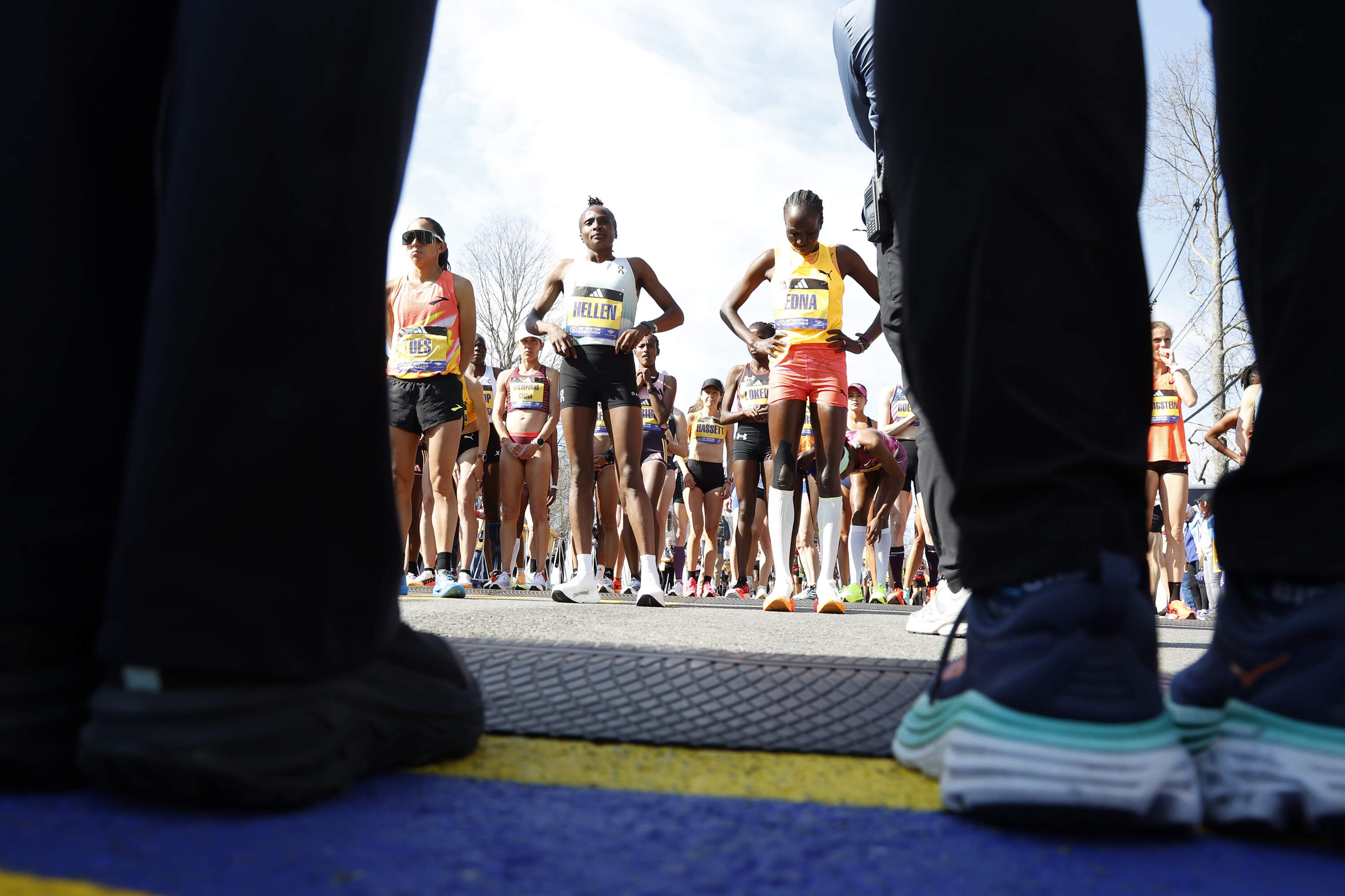 Des Linden, Hellen Obiri and Edna Kiplagat stand at the Boston Marathon starting line before the start of the 2024 race. (Mary Schwalm/AP)