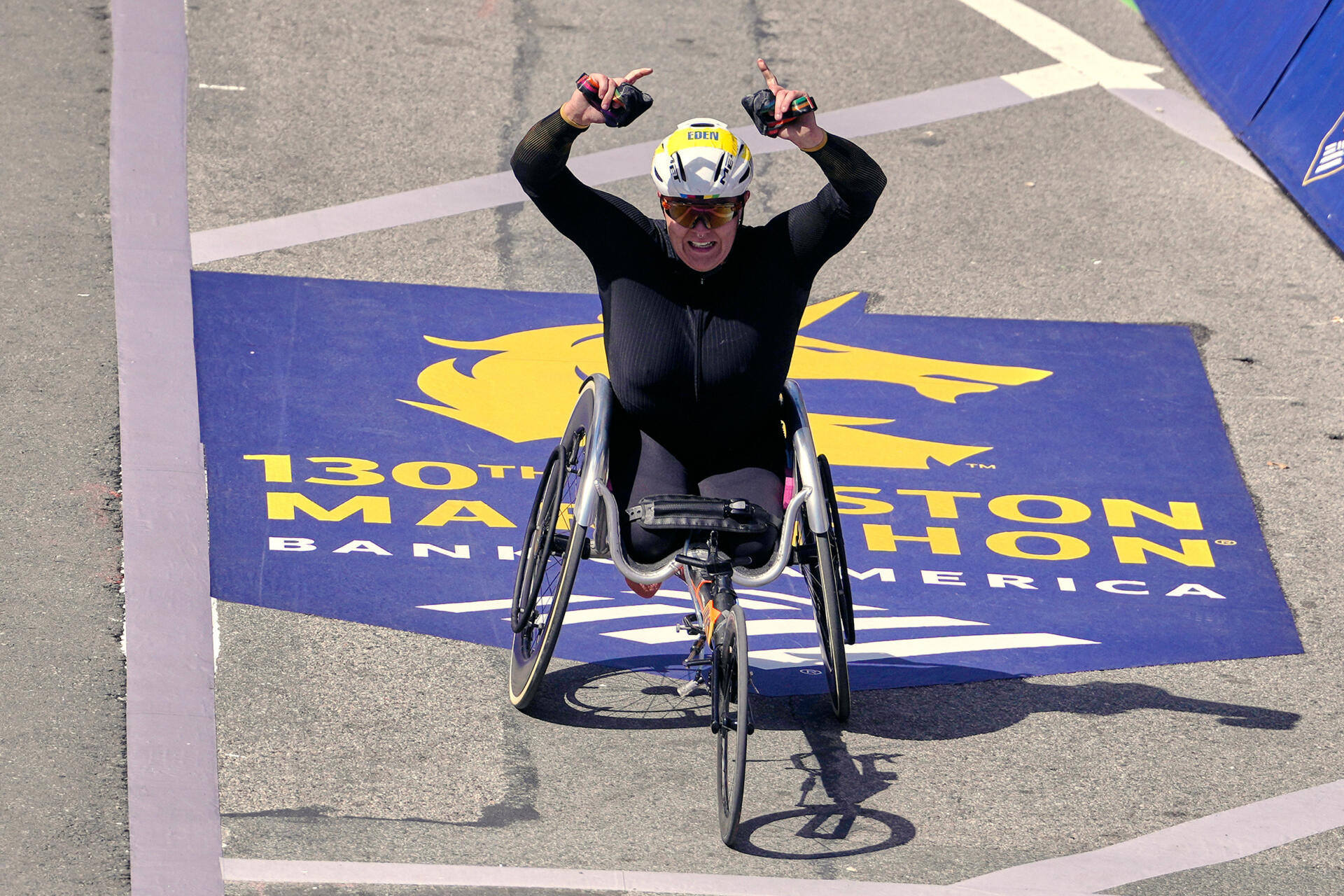 Eden Rainbow-Cooper, of Portsmouth, England, raises her arms while approaching the finish line while winning the women's wheelchair division of the Boston Marathon, Monday, April 20, 2026. (Charles Krupa/AP)