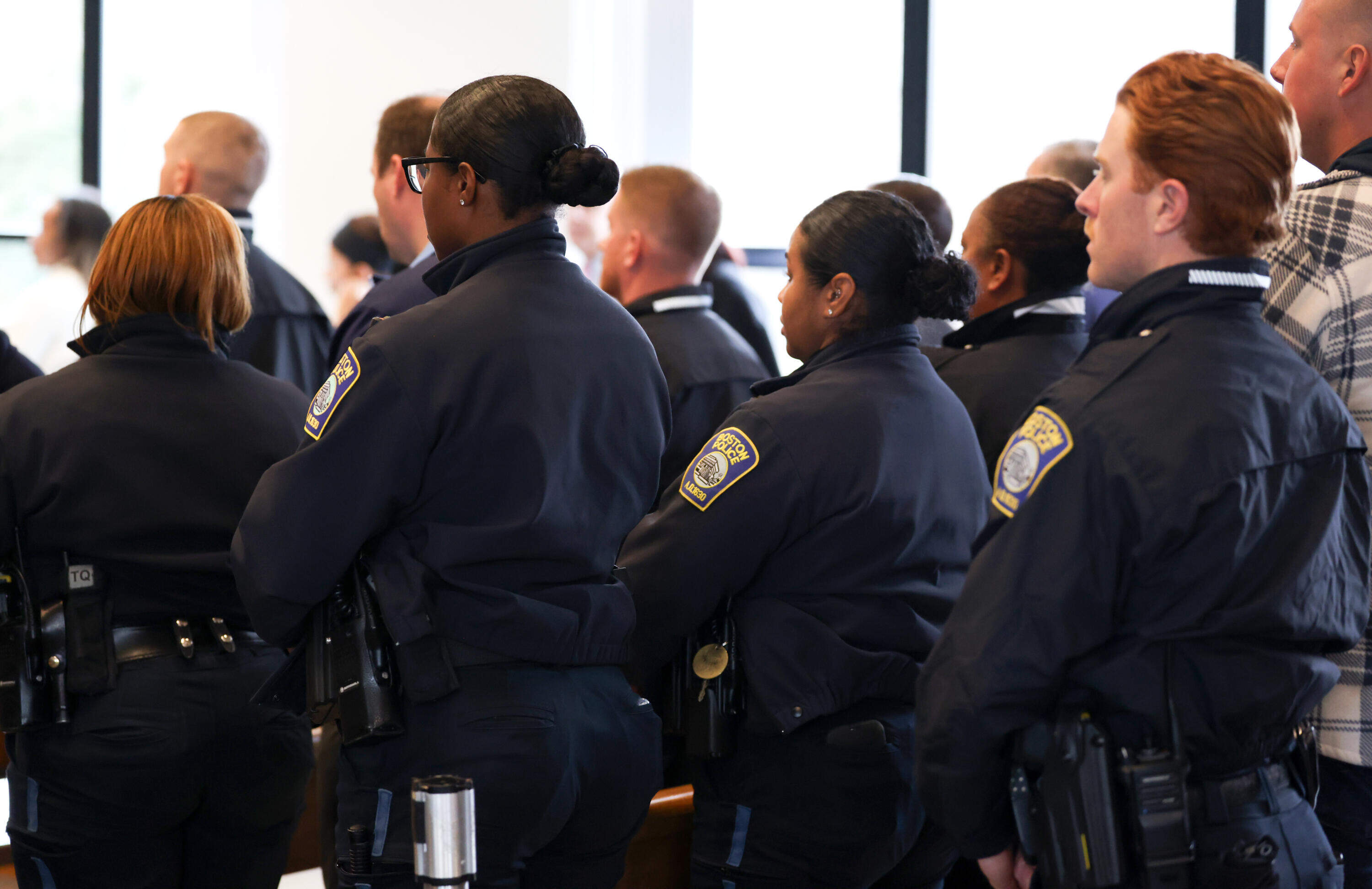 Boston Police officers leave the courtroom after their colleague, Nicholas O'Malley, pleaded not guilty during his arraignment in Roxbury Municipal Court in Boston on March 19 on manslaughter charges in the fatal shooting of Stephenson King.