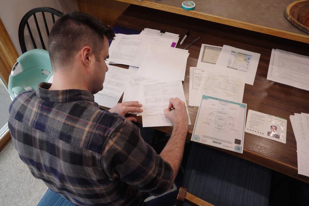 Zach Loud works to complete his application for Canadian citizenship at his family's home in Farmington, Minn., April 17, 2026. (Mark Vancleave/AP)