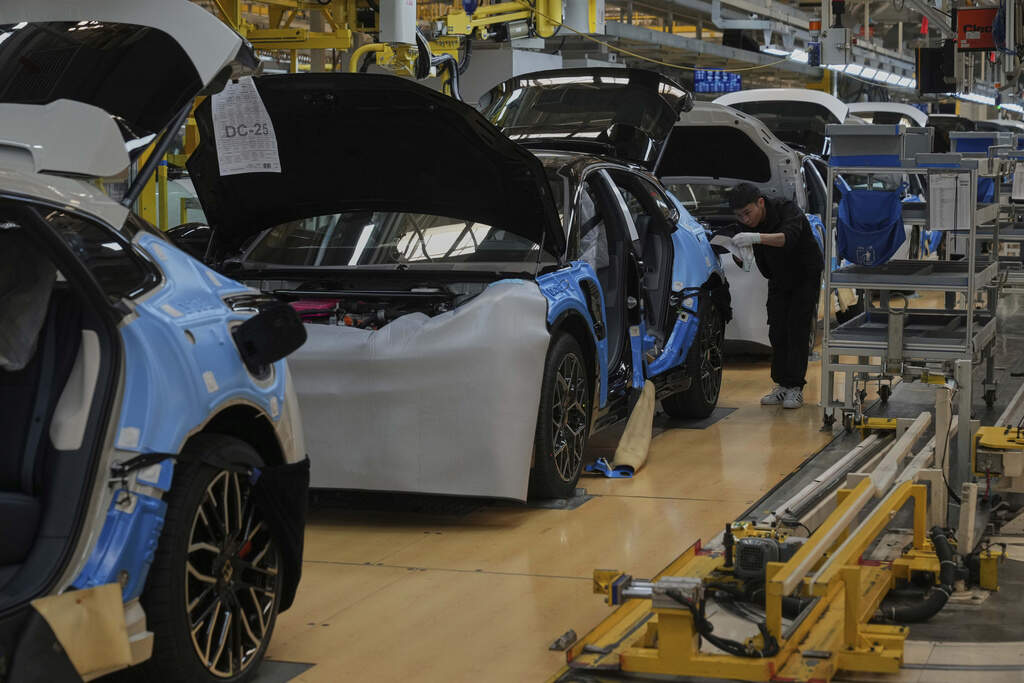 A worker assembles the Zeekr 001 EV model at the Chinese automaker Zeekr assembly plant, in Ningbo, east China's Zhejiang Province, Wednesday, April 17, 2025. (AP Photo/Andy Wong)