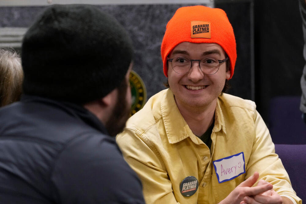 Avery Seuter talks with a fellow supporter of U.S. Senate candidate Graham Platner during a Platner-themed trivia night, Thursday, March 26, 2027, in Kittery, Maine. (Robert F. Bukaty/AP)