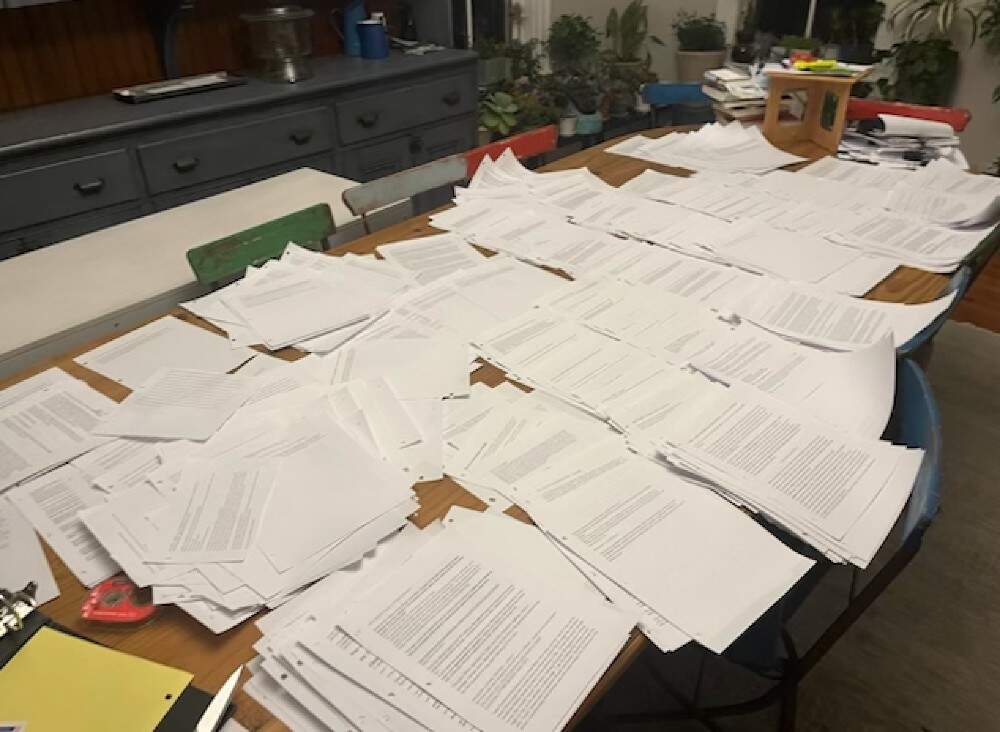 Pages of the author's work while writing "Love &amp; Other Monsters," spread out on her kitchen table. (Courtesy Emily Franklin)
