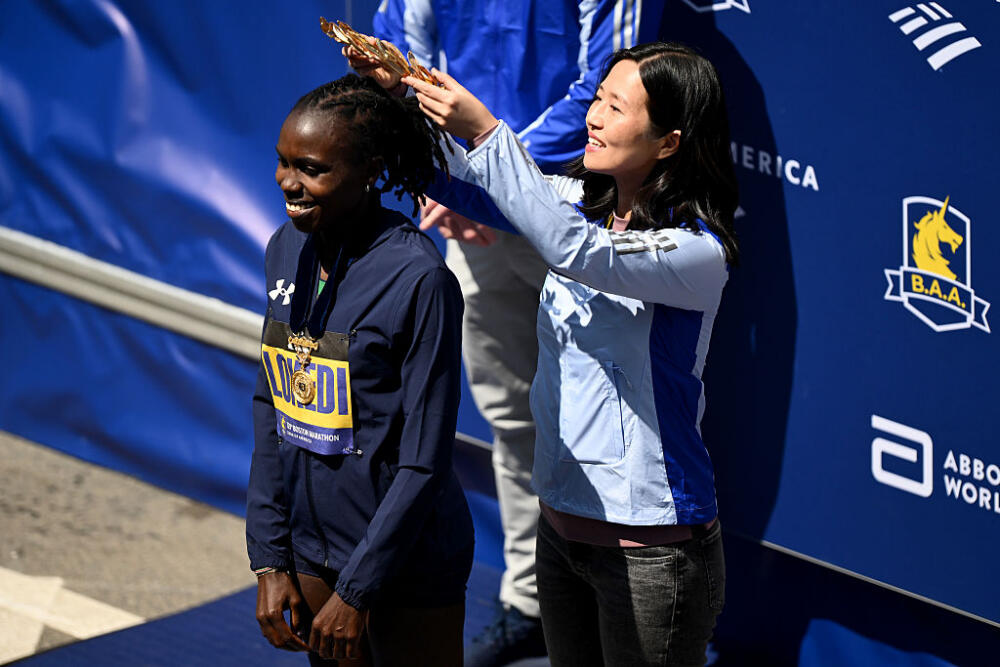 Boston Mayor Michelle Wu (R) places an olive wreath crown on Sharon Lokedi of Kenya (L) after winning the 129th Boston Marathon Women's division on April 21, 2025 in Boston, Massachusetts. (Brian Fluharty/Getty Images)