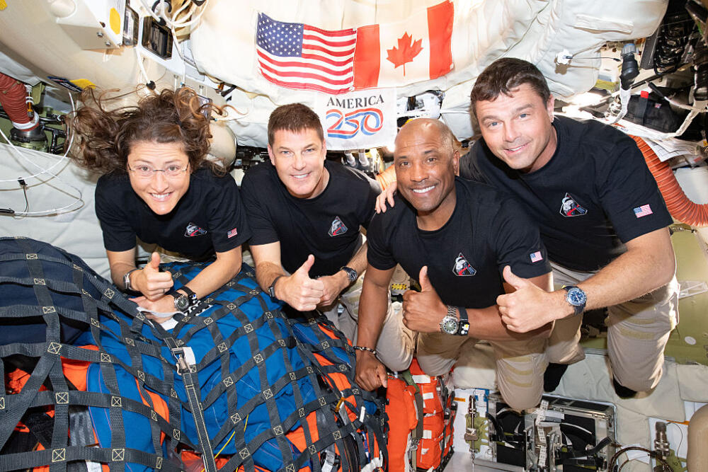 In this image provided by NASA, The Artemis II crew – (from left) Mission Specialist Christina Koch, Mission Specialist Jeremy Hansen, Pilot Victor Glover, and Commander Reid Wiseman – pause for a group photo inside the Orion spacecraft on their way home. (NASA via Getty Images)