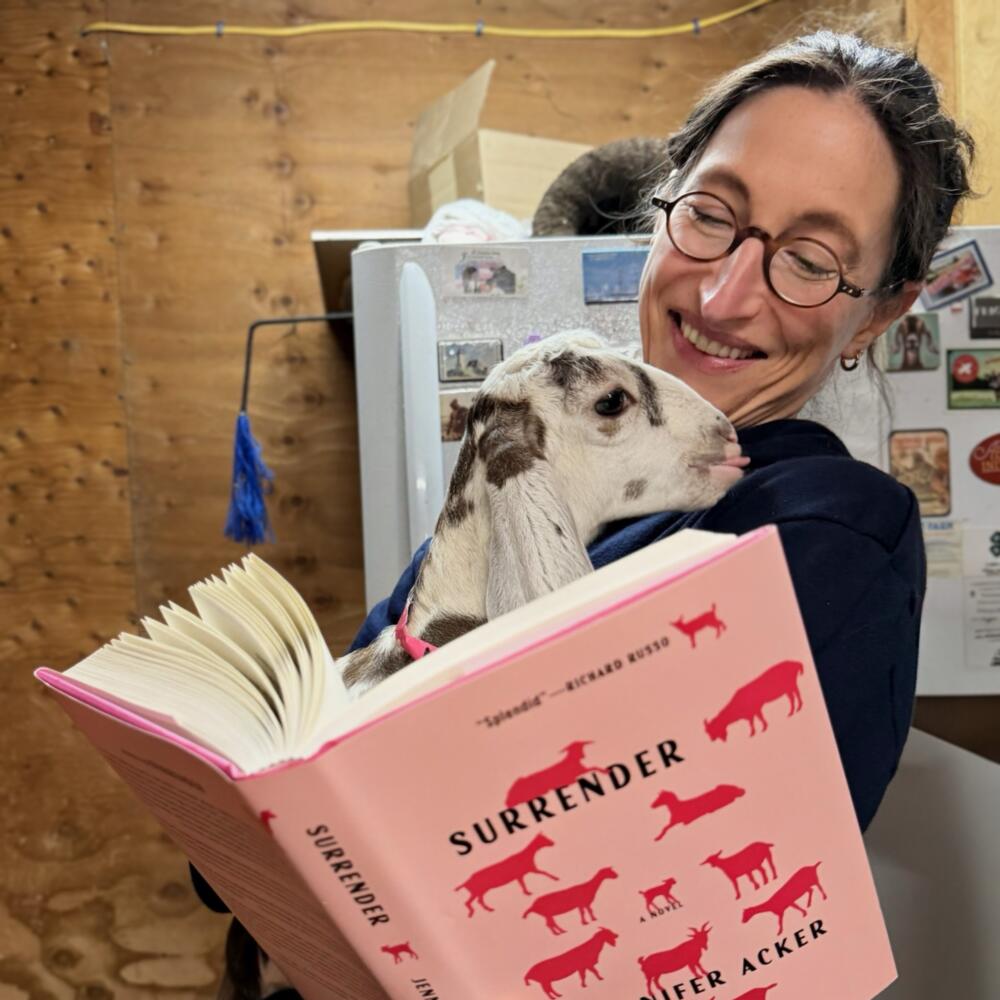 Author Jennifer Acker holds her book "Surrender" and a goat from Thomas Farm &amp; Dairy in Sunderland, Mass. (Courtesy Jennifer Acker)