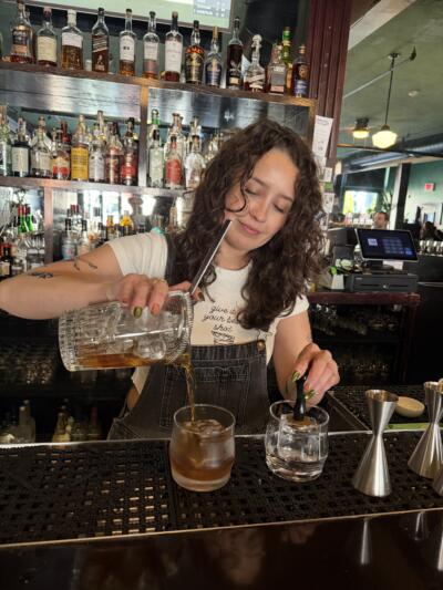 Bartender Tahnee Sosa pours a cocktail at Tall Order in Somerville. (Amy Sokolow/WBUR)