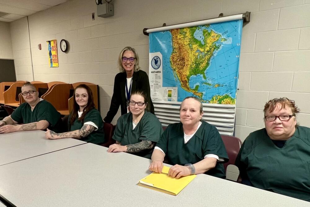 Students in the memoir class at the Barnstable County Correctional Facility — Jess Hutchins, Haley Hart LeBrie, Cassie Oliveira, Teri Hathaway, and Cheryl Gillette — pose with instructor K.C. Myers. (Jennette Barnes/CAI)