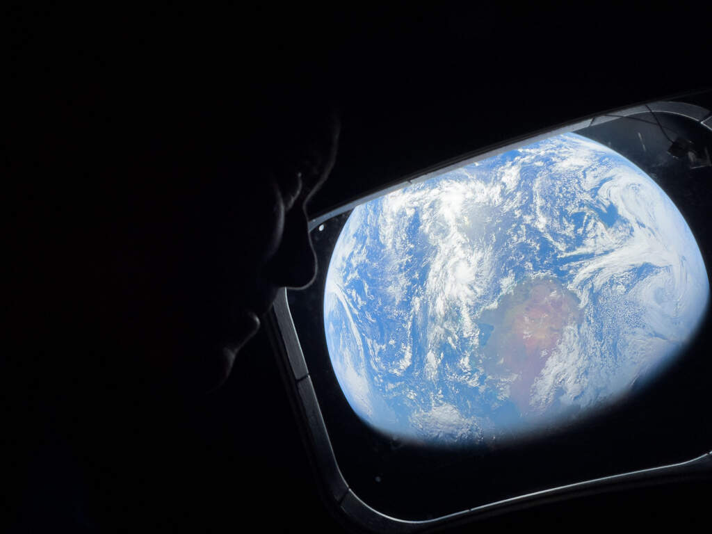 Artemis II Commander Reid Wiseman peers back at Earth out of one of the Orion spacecraft's main cabin windows last Thursday.