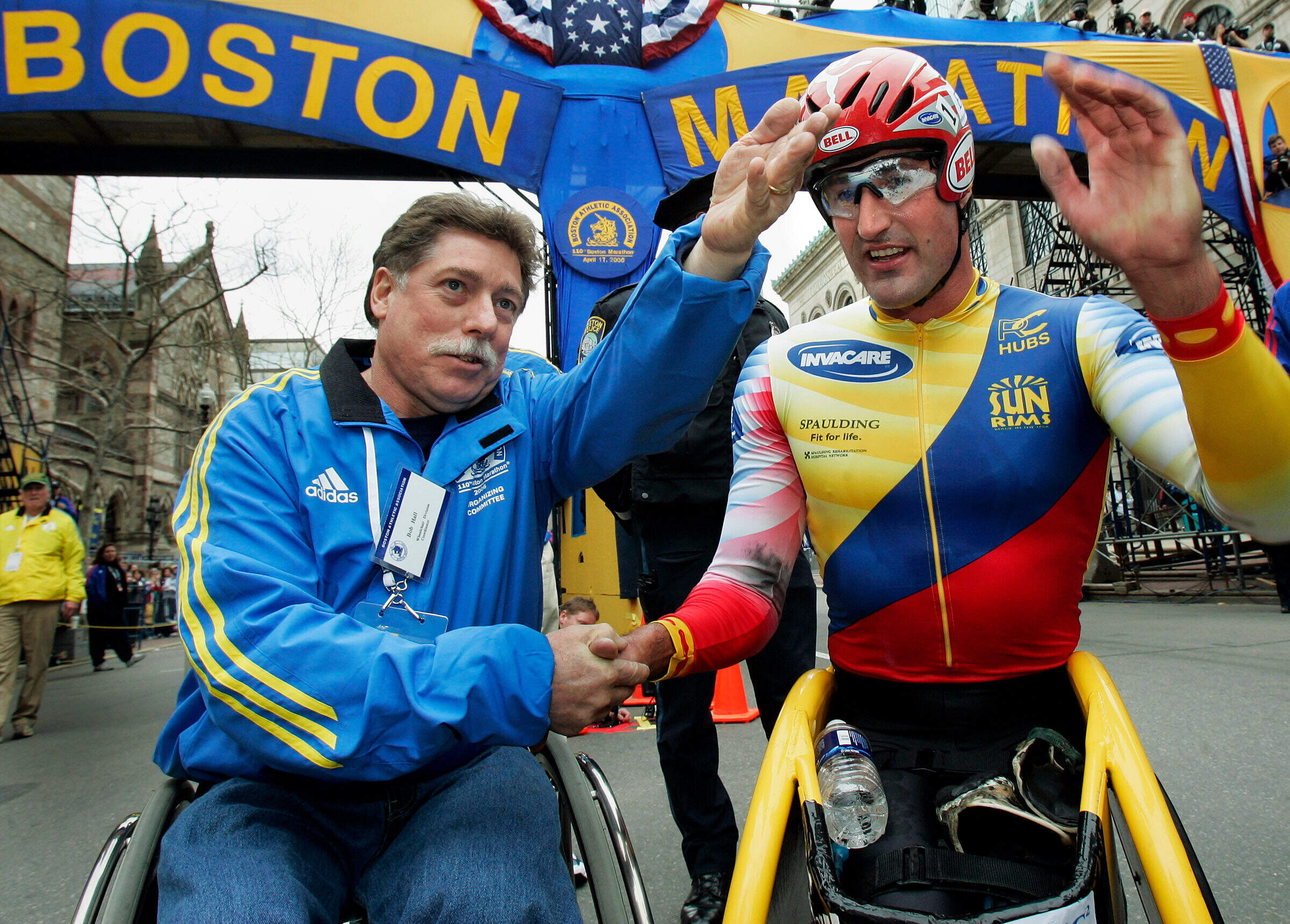 Ernst Van Dyk of South Africa, right, shakes hands with former wheelchair winner Bob Hall, after he won the mens wheelchair division of the 110th running of the Boston Marathon, Monday, April 17, 2006. (Elise Amendola/AP, File)