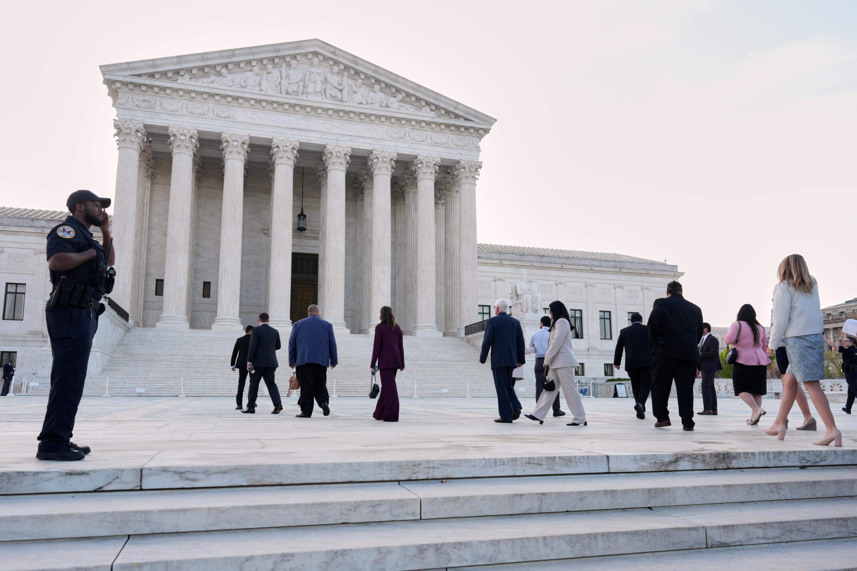 People arrive Wednesday morning at the U.S. Supreme Court on Capitol Hill in Washington, D.C