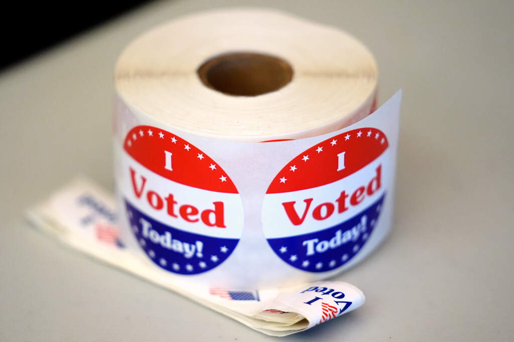 A spool of stickers rests on a table at a polling station during Massachusetts state primary voting, Sept. 3, 2024, in Newton, Mass. (Steven Senne/AP, File)