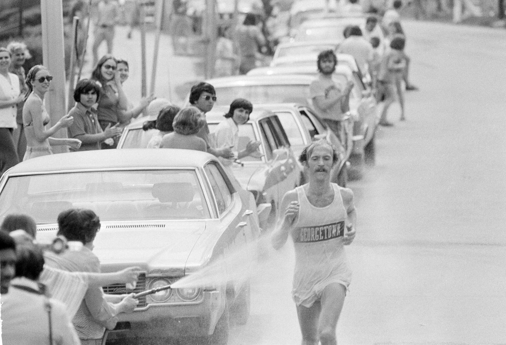 Jack Fultz, 27, of Georgetown University, is sprayed with a hose as he runs through Wellesley, during the 80th annual Boston Marathon on April 19, 1976. (AP file photo)