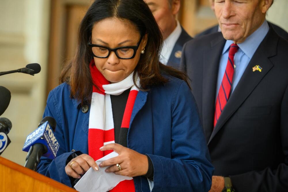 Cheshire Board of Education Chair Samantha Rosenberg pauses while speaking during a press conference held by lawmakers and advocates demanding Cheshire High School student Rihan be returned after he was detained by ICE on April 10, 2026. (Mark Mirko/Connecticut Public, File)