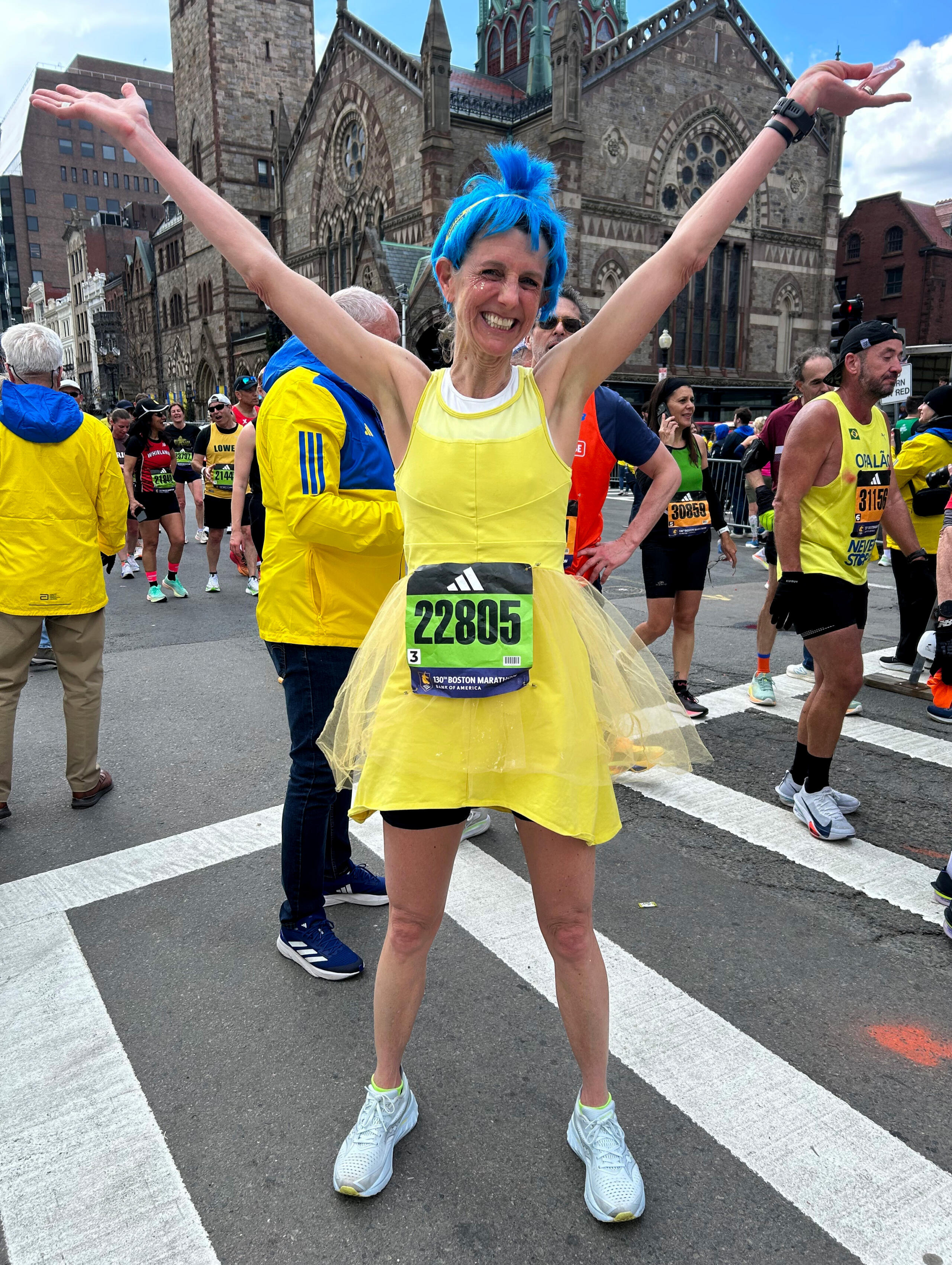 Emily Huff, from Seattle, dressed as the character Joy from "Inside Out" after crossing the Boston Marathon finish line. (Martha Bebinger/WBUR)