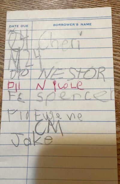 A library borrowing card from 1981, signed by children. (Courtesy Kate Peltz)