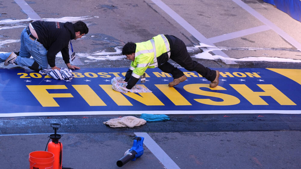 Workers scrub the marathon finish line clean on Monday morning. (Charles Krupa/AP)