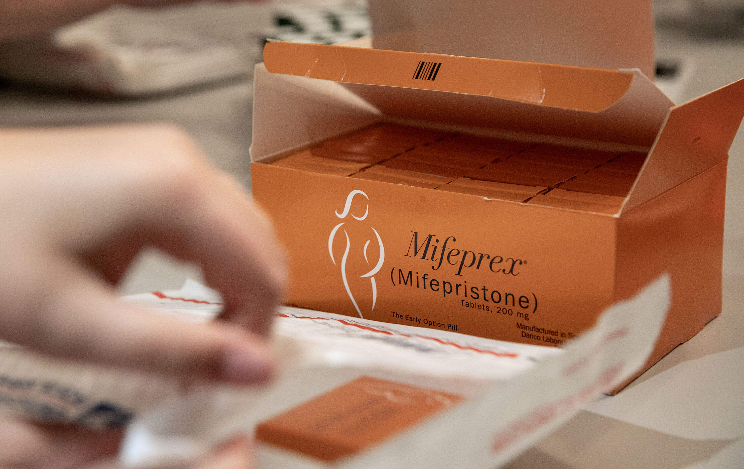Volunteers pack envelopes with mifepristone and information in Massachusetts in 2025. (Robin Lubbock/WBUR, File)