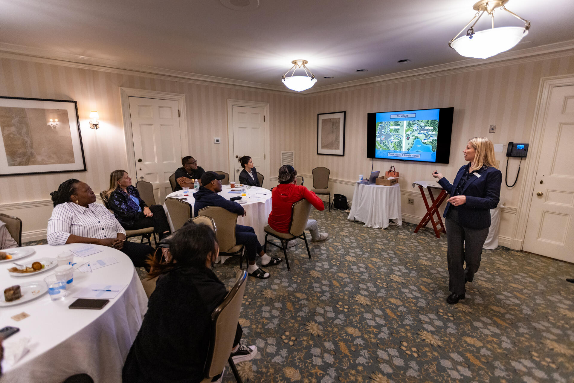Recruiting and training manager Kari Monahan leads an orientation for new workers, the group mostly made up of J-1 and H-2B seasonal workers, at the Ocean Edge Resort and Golf Club in Brewster. (Jesse Costa/WBUR)