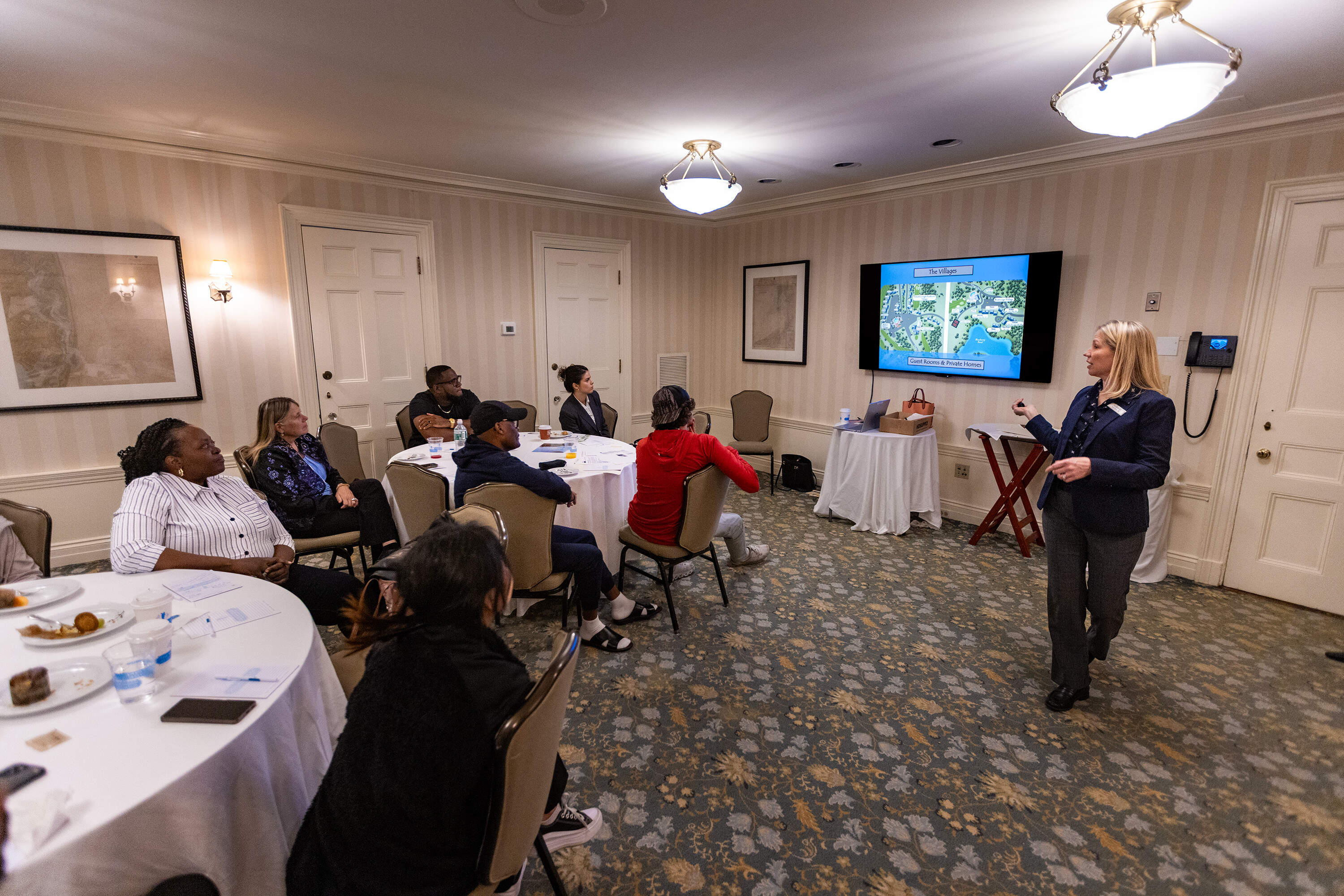 Recruiting and training manager Kari Monahan leads an orientation for new workers, the group mostly made up of J-1 and H-2B seasonal workers, at the Ocean Edge Resort and Golf Club in Brewster. (Jesse Costa/WBUR)