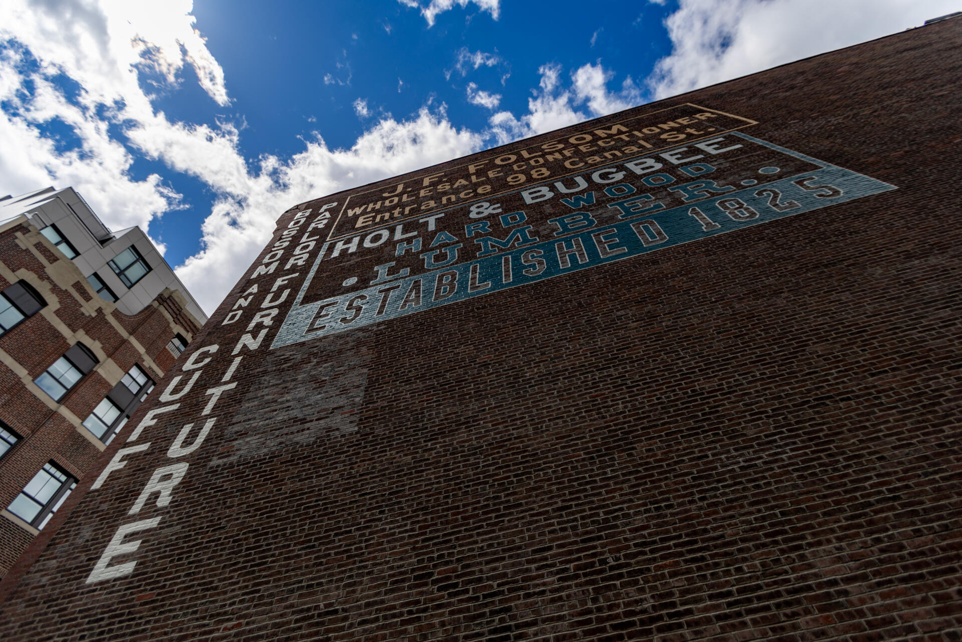 The restored Holt & Bugbee lumber company sign in the West End of Boston. (Jesse Costa/WBUR)