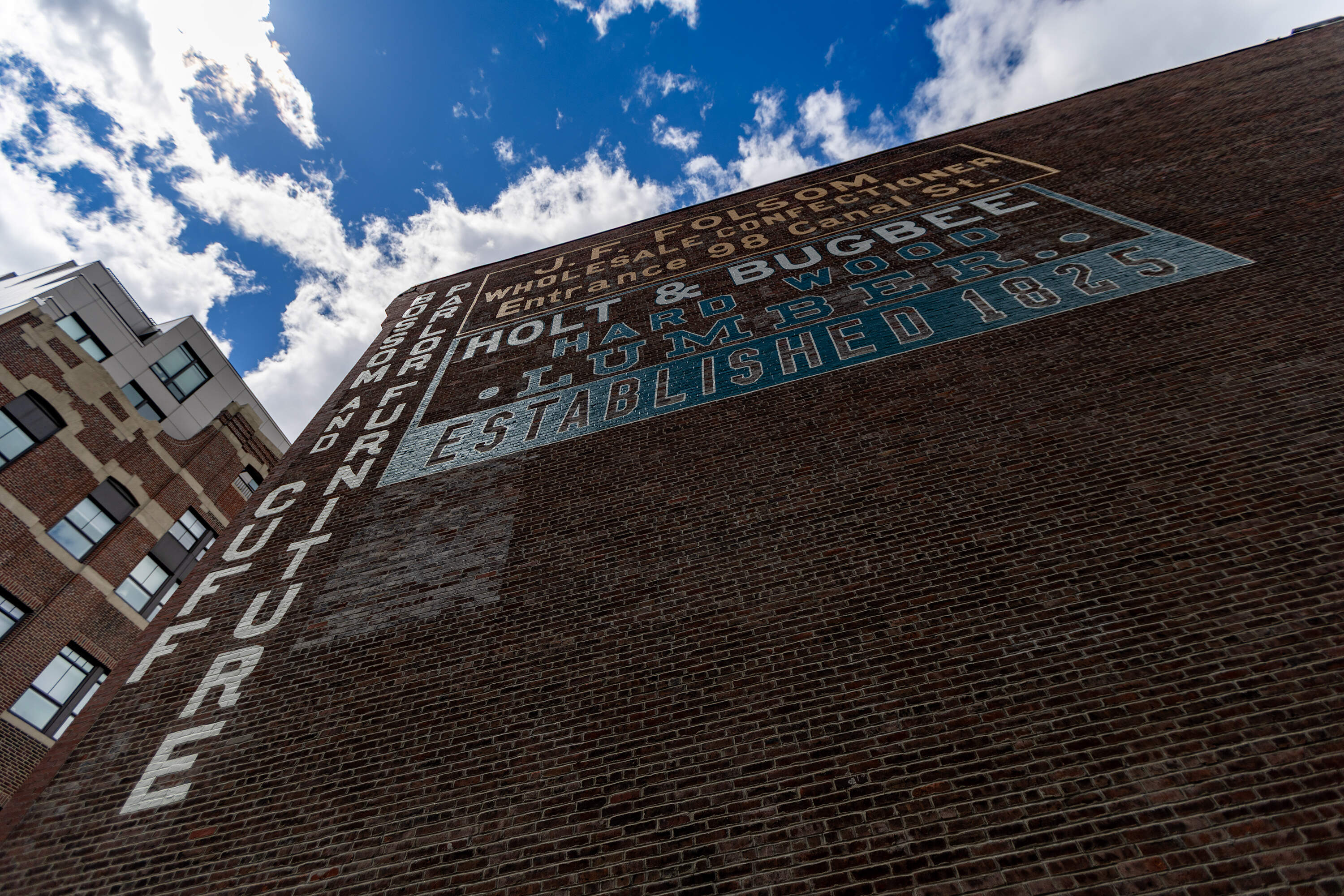 The restored Holt & Bugbee lumber company sign in the West End of Boston. (Jesse Costa/WBUR)