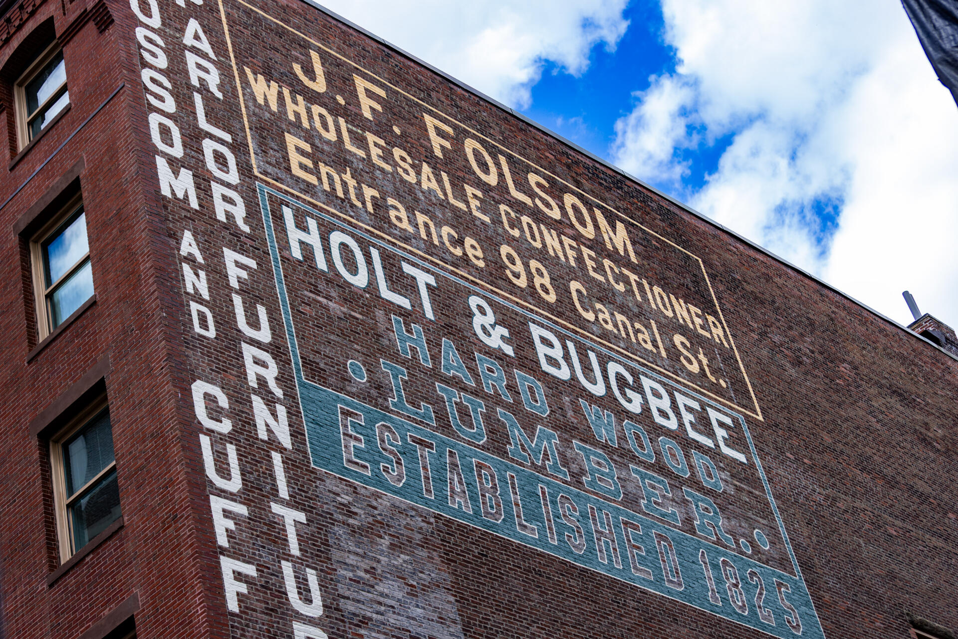 The restored Holt & Bugbee lumber company sign in the West End of Boston. (Jesse Costa/WBUR)