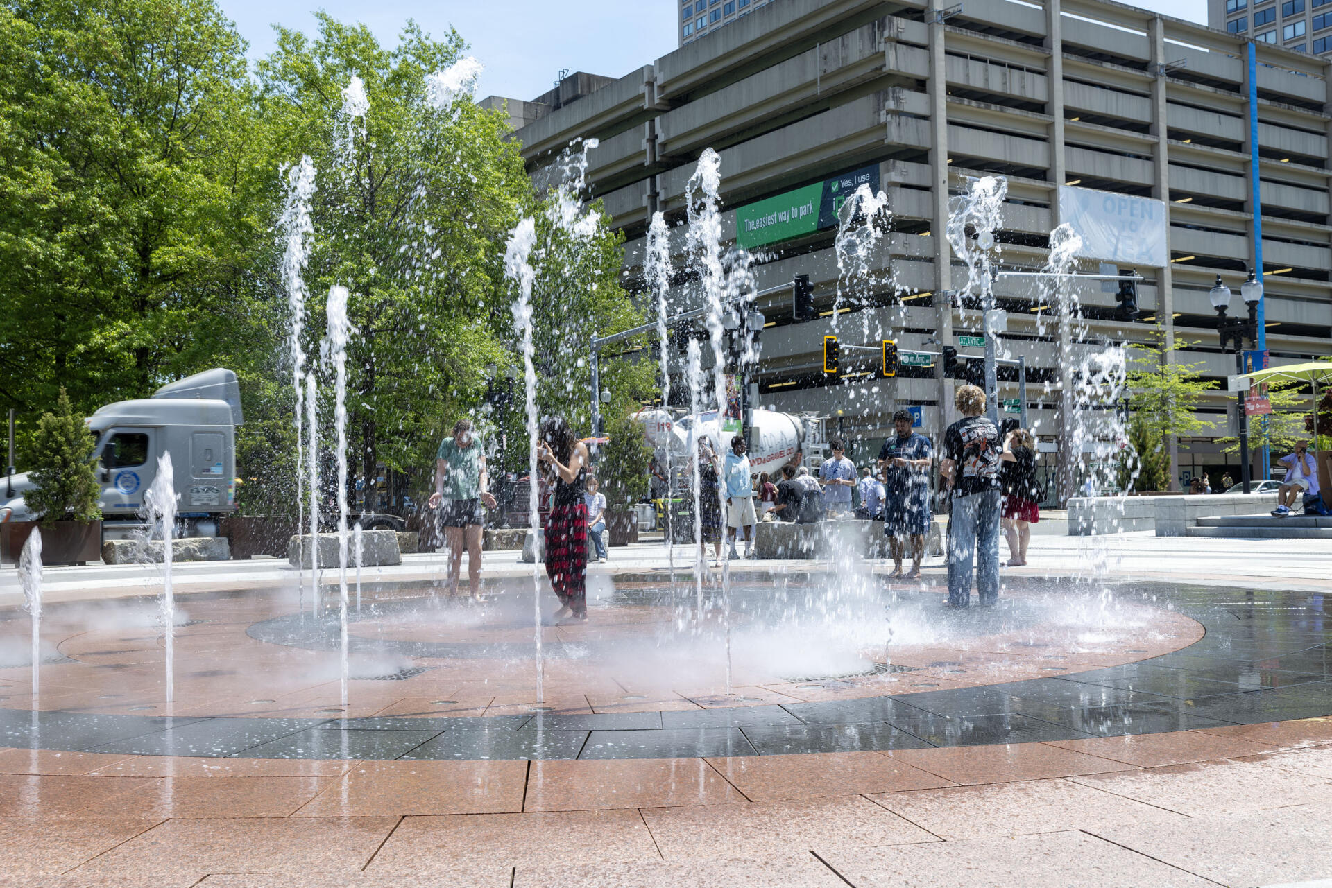 Visitors to the Rose Kennedy Greenway cool off in the Rings Fountain as temperatures in Boston soar into the 90s. (Robin Lubbock/WBUR)